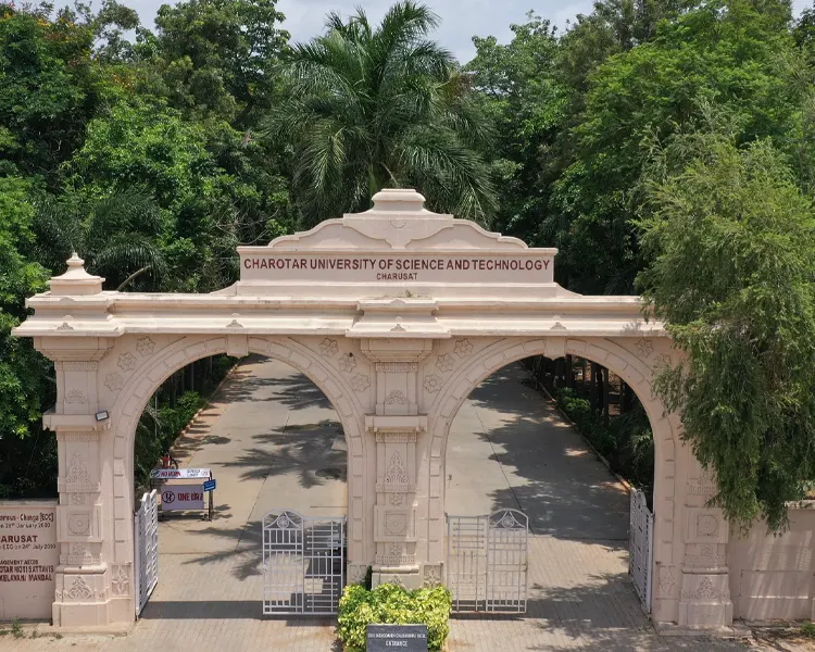 Senital image of the campus main entrance with trees and flowers